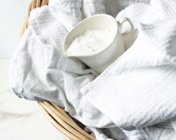 Laundry basket with laundry and cup of powder Laundry basket with laundry and cup of powder