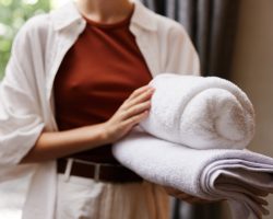 Woman clean hygiene towel hotel home service stack female background laundry closeup Woman clean hygiene towel hotel home service stack female background laundry closeup